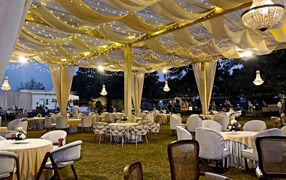Draped marquee with fairy lights and table seating — tent house and catering in Panchkula Haryana by Sandeep Tent & Catering